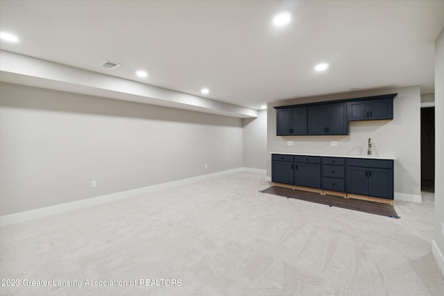 interior space featuring sink and light colored carpet