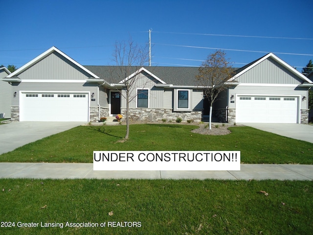 view of front facade with a front yard and a garage