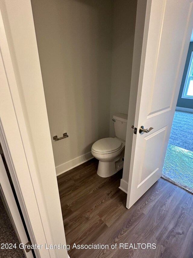 bathroom featuring hardwood / wood-style floors and toilet