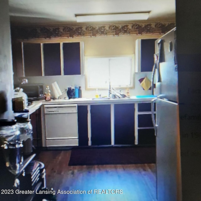 kitchen with dark hardwood / wood-style floors, dishwasher, and sink