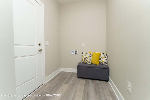 laundry area with hookup for a washing machine and light hardwood / wood-style flooring