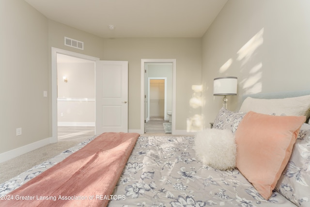 bedroom featuring a spacious closet, carpet floors, and a closet