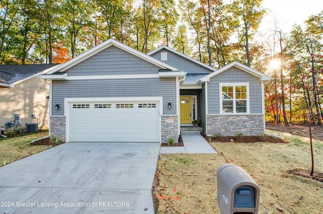 view of front of home with cooling unit and a garage