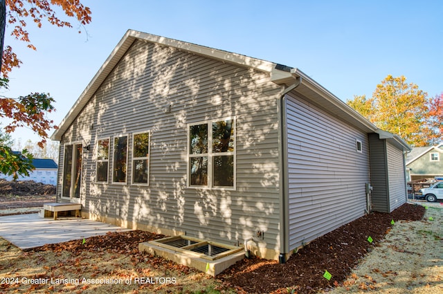 view of property exterior with a patio area