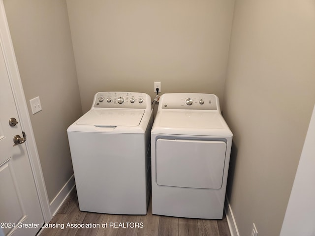 laundry room featuring washer and dryer and dark hardwood / wood-style flooring