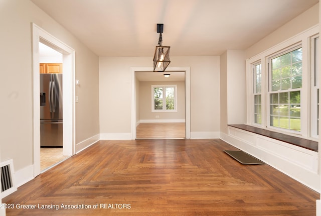 unfurnished dining area featuring parquet flooring