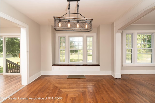 unfurnished dining area with parquet flooring and a wealth of natural light