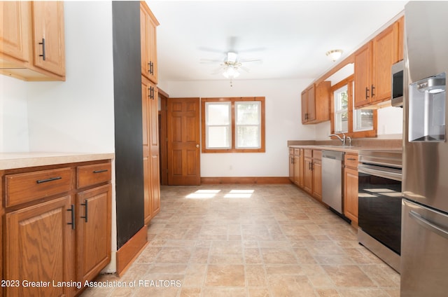 kitchen featuring ceiling fan, appliances with stainless steel finishes, and sink