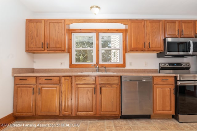 kitchen with appliances with stainless steel finishes and sink