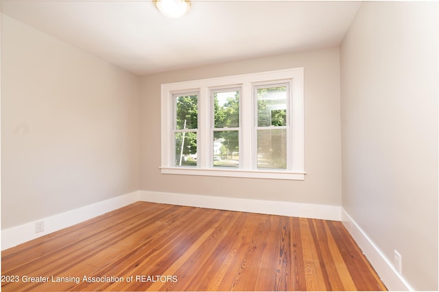 empty room with hardwood / wood-style flooring