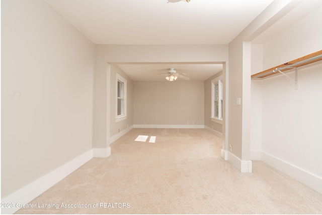 carpeted empty room featuring ceiling fan