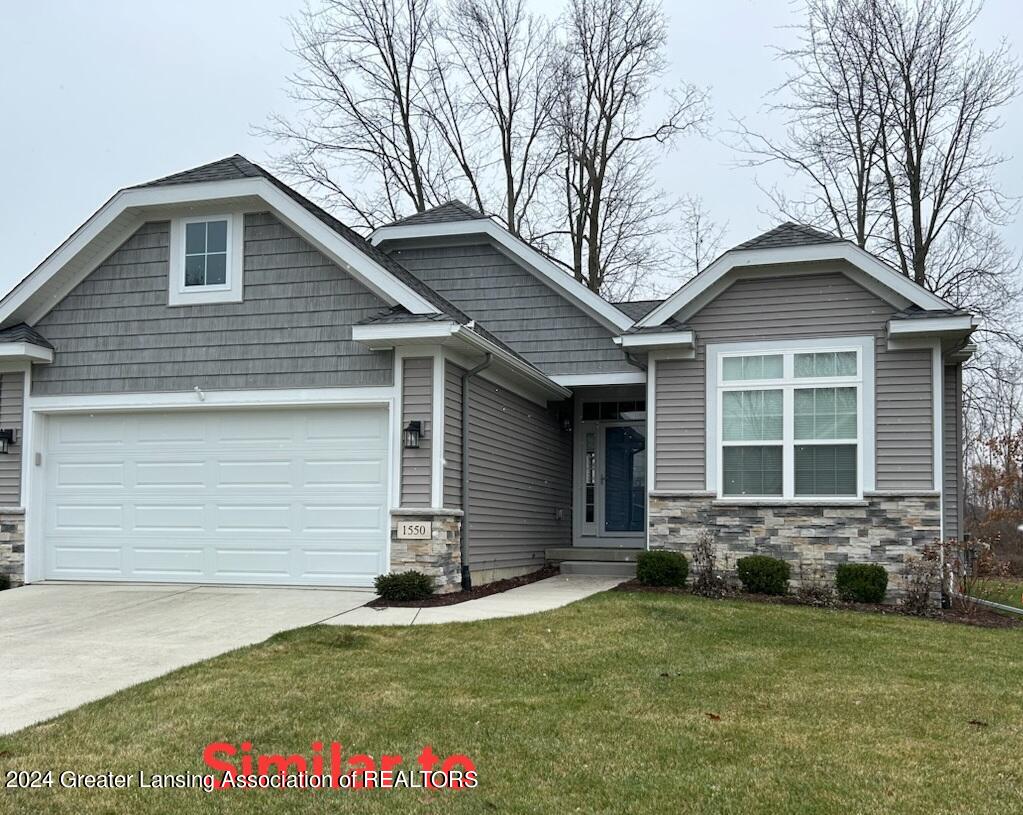 craftsman-style house with a garage and a front lawn