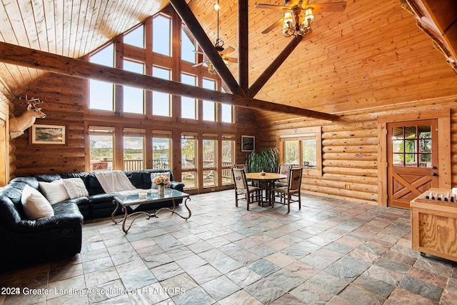 tiled living room with ceiling fan, high vaulted ceiling, log walls, and wooden ceiling