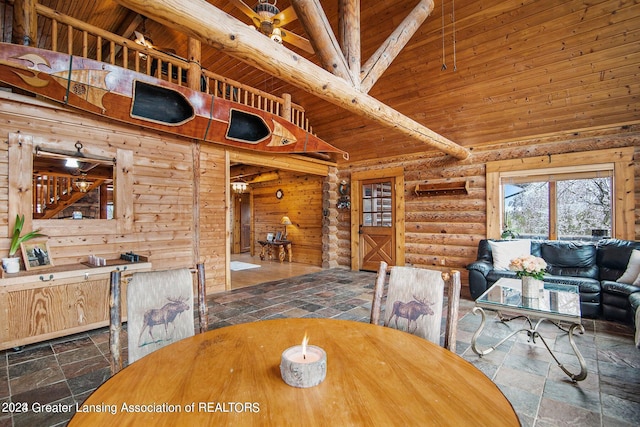 tiled dining room with beam ceiling, high vaulted ceiling, log walls, and wood ceiling