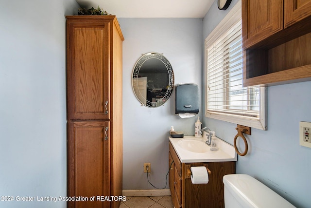 bathroom featuring tile flooring, large vanity, and toilet