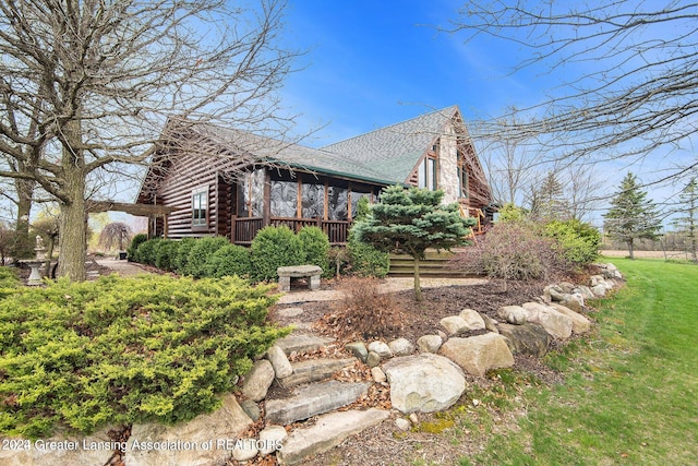 view of side of home with a lawn