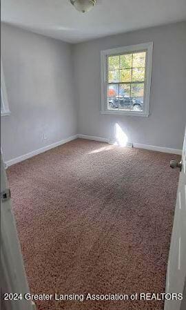 unfurnished room with carpet flooring