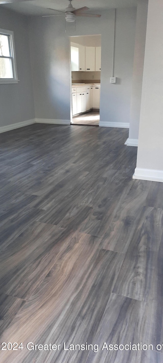 interior space with dark hardwood / wood-style floors and ceiling fan