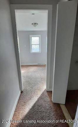 hallway featuring carpet flooring