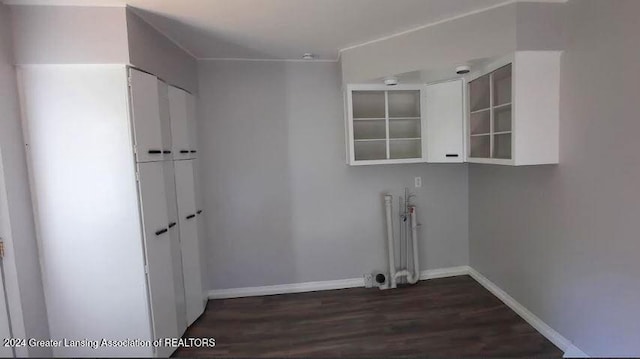 laundry area with radiator and dark wood-type flooring