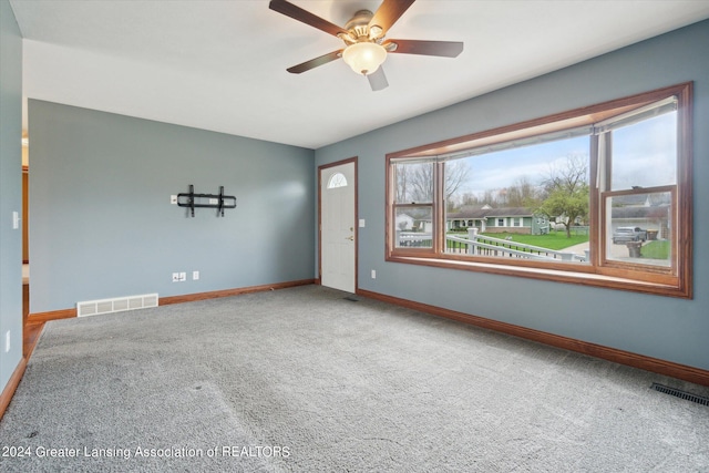 spare room featuring ceiling fan and carpet