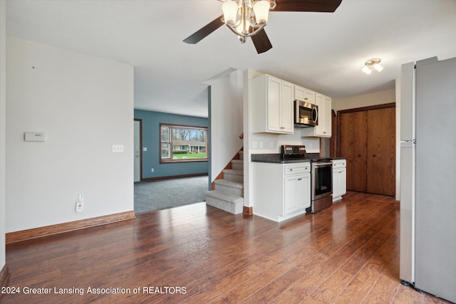 kitchen featuring appliances with stainless steel finishes, wood-type flooring, ceiling fan, and white cabinets