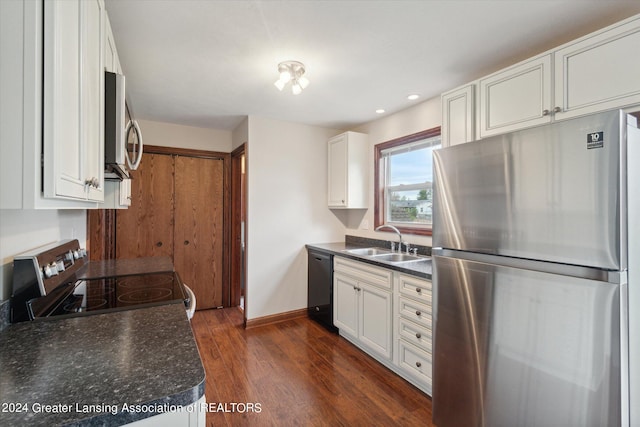 kitchen with white cabinets, sink, stainless steel appliances, and dark hardwood / wood-style flooring