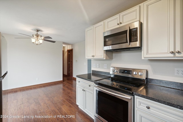 kitchen with appliances with stainless steel finishes, ceiling fan, white cabinetry, and dark wood-type flooring