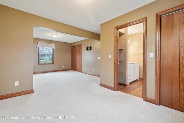 carpeted spare room featuring a textured ceiling