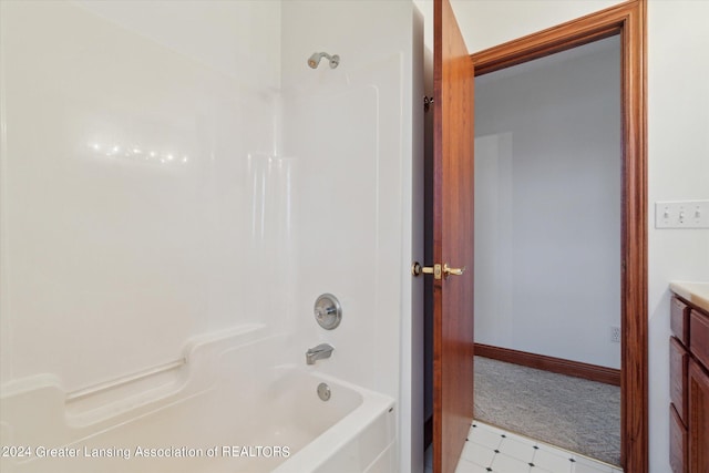 bathroom featuring vanity, tile floors, and  shower combination