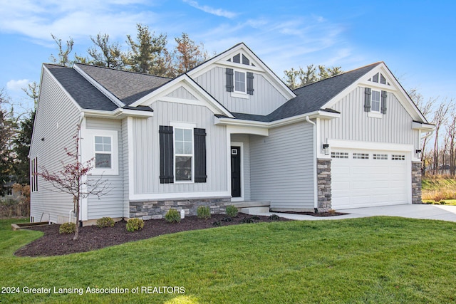 craftsman-style home featuring a front yard and a garage