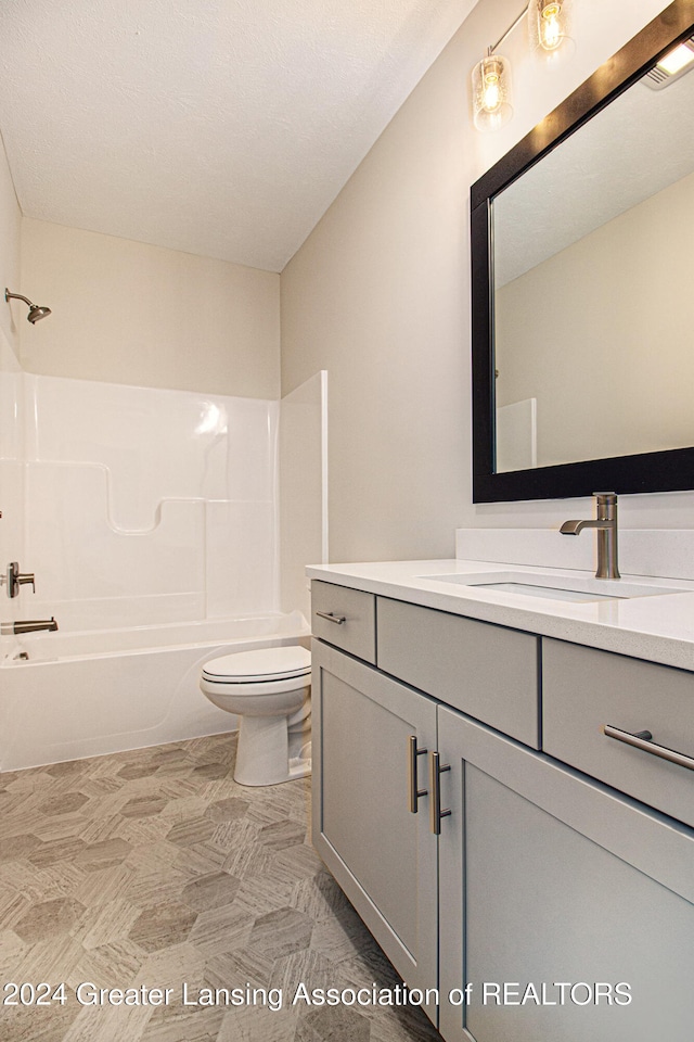 full bathroom featuring vanity, tub / shower combination, and toilet