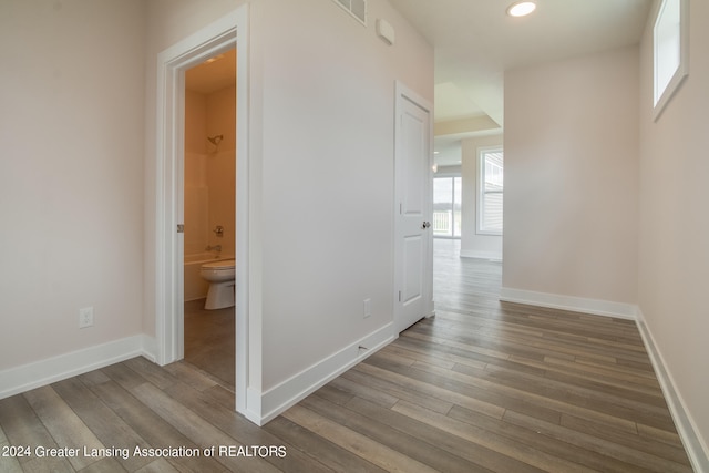 hallway with hardwood / wood-style flooring