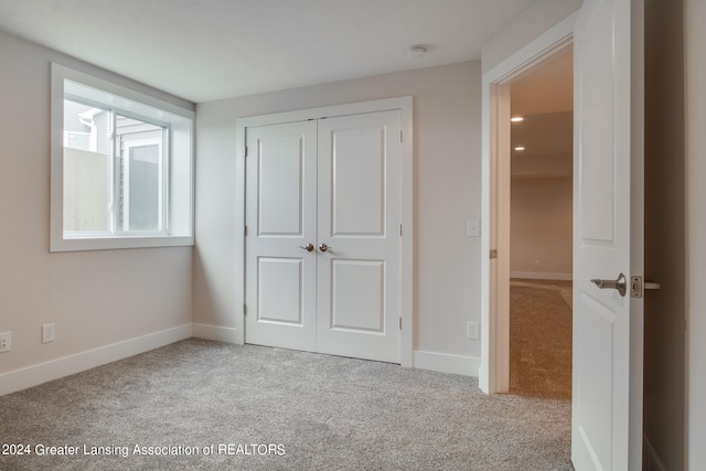 unfurnished bedroom featuring a closet and carpet