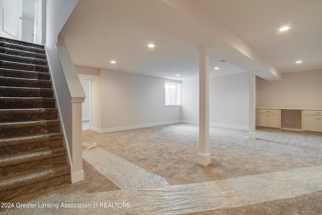 basement featuring light colored carpet