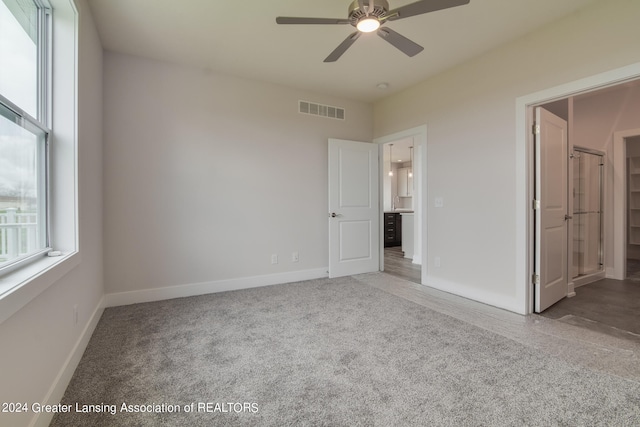 spare room with carpet floors and ceiling fan