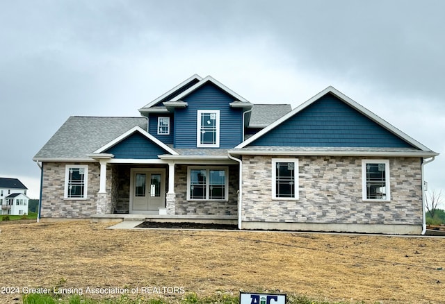 craftsman inspired home with a front lawn