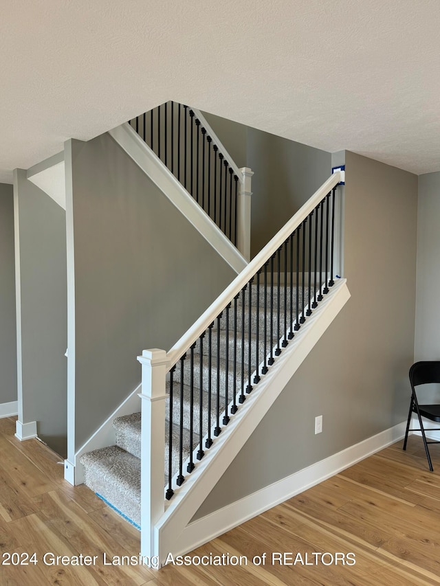 stairway with wood-type flooring