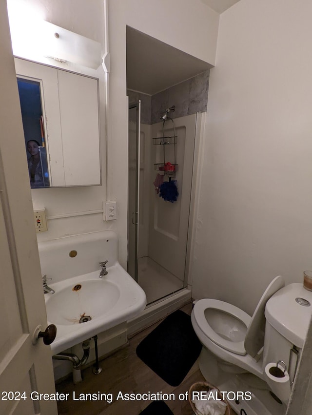 bathroom featuring an enclosed shower and toilet