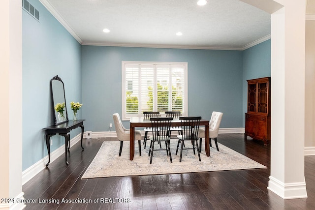 dining room with crown molding and dark wood-type flooring