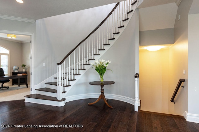 stairs featuring hardwood / wood-style flooring and crown molding