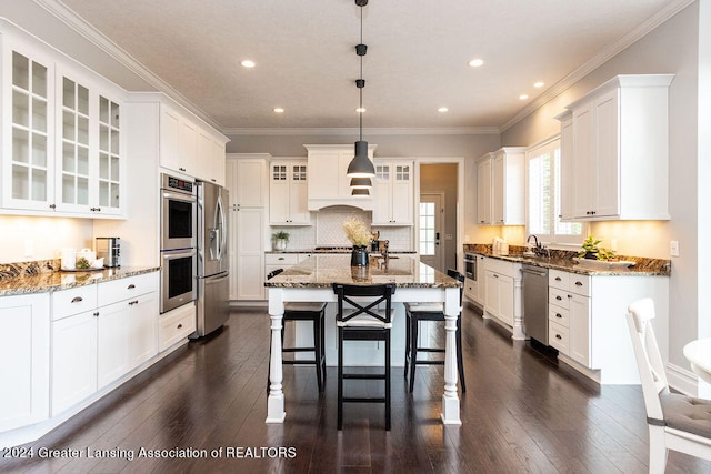 kitchen featuring white cabinetry, decorative light fixtures, dark hardwood / wood-style floors, and appliances with stainless steel finishes