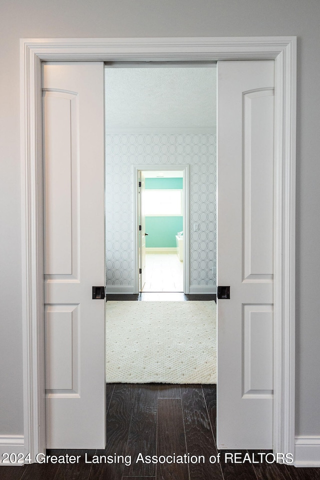 corridor with dark hardwood / wood-style flooring