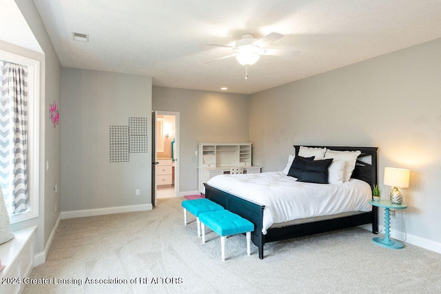 carpeted bedroom featuring ceiling fan and ensuite bathroom