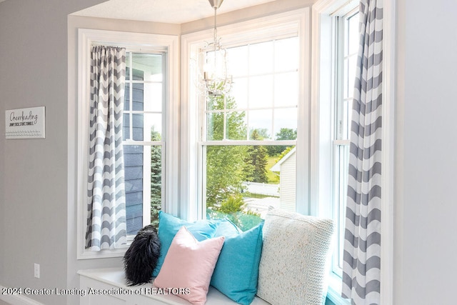 doorway to outside with plenty of natural light and an inviting chandelier