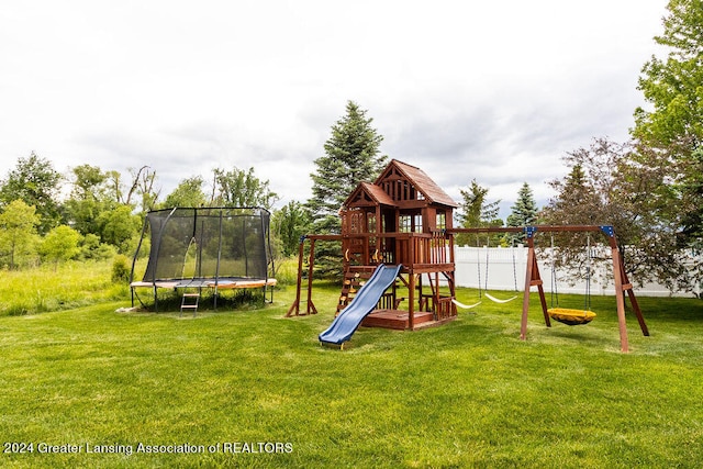 view of play area with a trampoline and a lawn