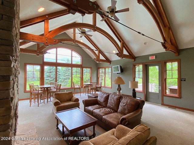 living room with light carpet, beam ceiling, high vaulted ceiling, and ceiling fan