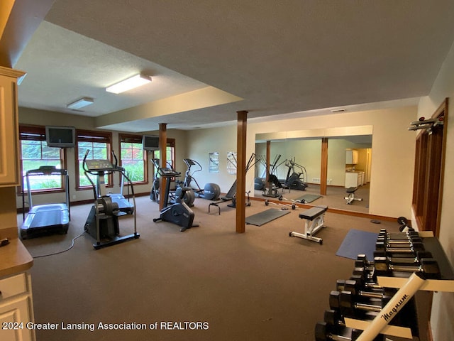 exercise room with a textured ceiling