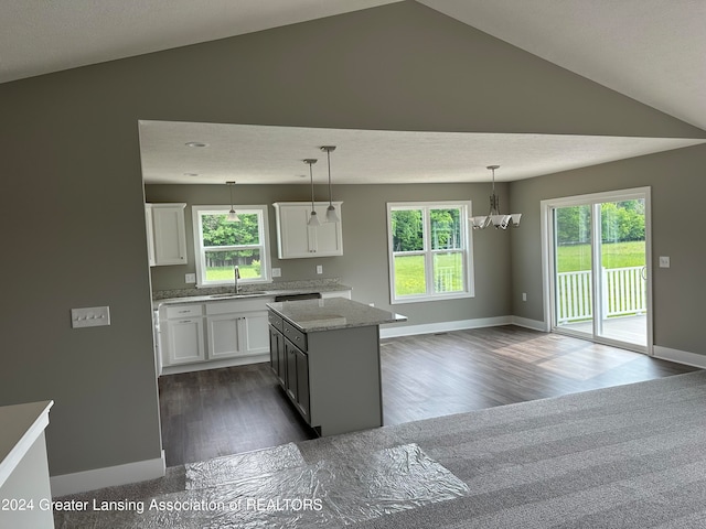 kitchen featuring a healthy amount of sunlight, white cabinets, dark hardwood / wood-style flooring, and sink