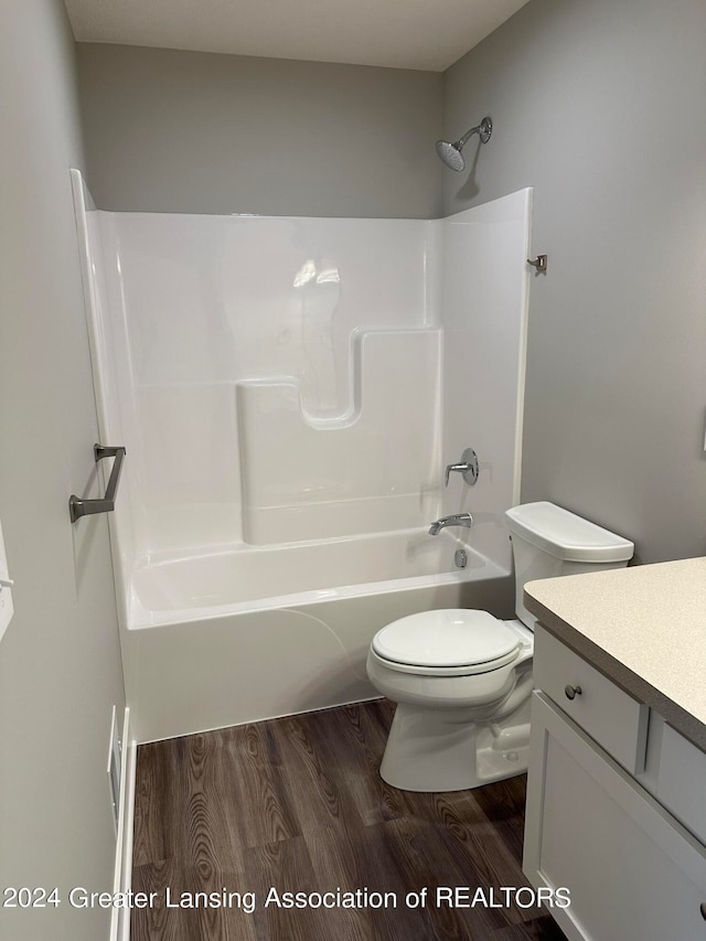 full bathroom featuring wood-type flooring, vanity, toilet, and shower / washtub combination